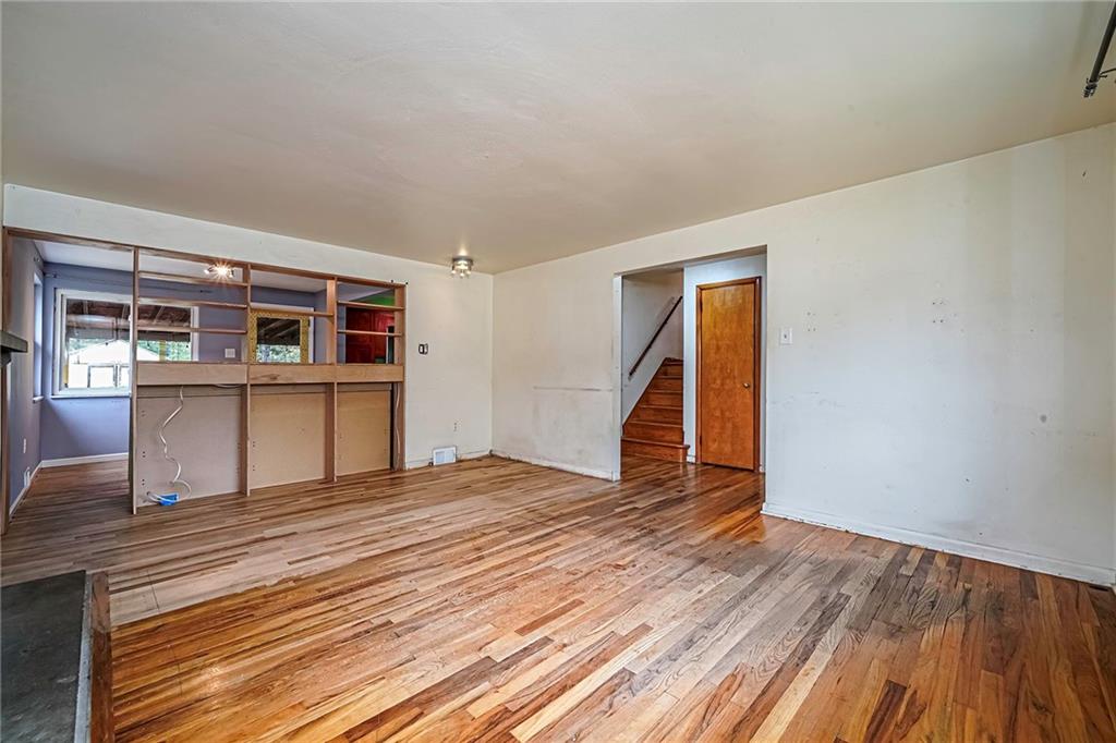 421 Sharon Road Coraopolis, PA 15108 - Photo 6 of 25 Spacious living room, highlighted by comfortable seating arrangements and designed to create a warm and inviting atmosphere, perfect for relaxation and entertaining.