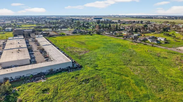 an aerial view of a residential houses with city view
