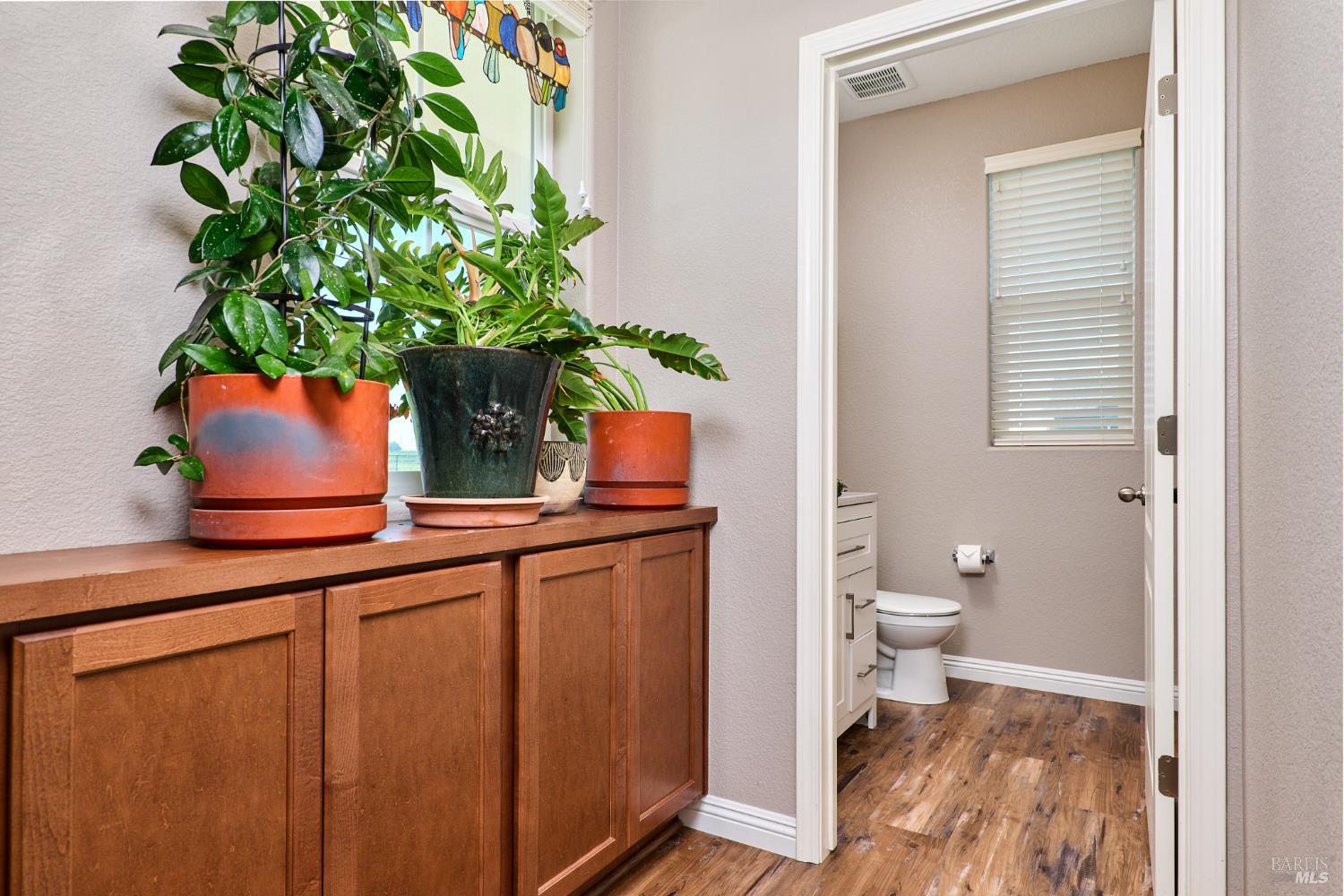 4398 Artisan Path, Unit 724 :2 Rio Vista, CA 94571 - Photo 2 of 24 a bathroom with a toilet a sink and mirror