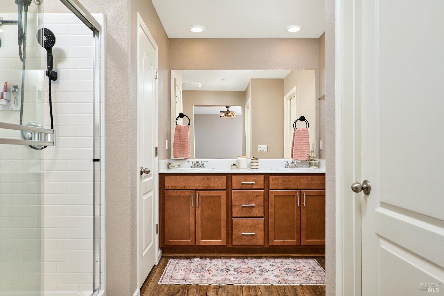 4398 Artisan Path, Unit 724 :2 Rio Vista, CA 94571 - Photo 23 of 24 a bathroom with a sink a mirror and a shower