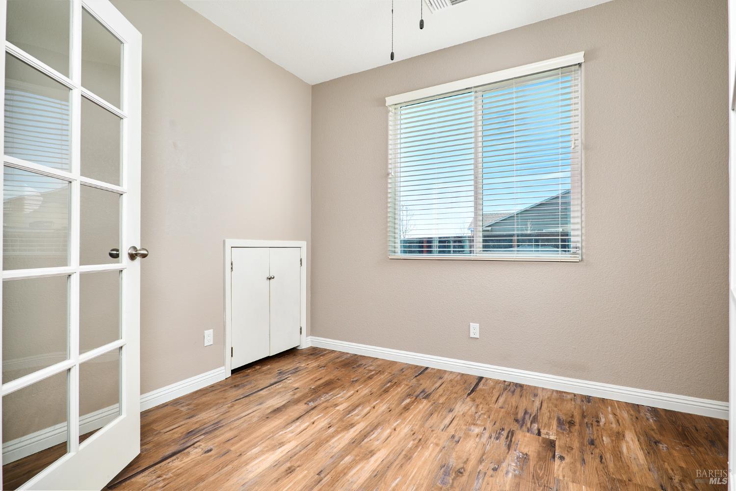 4398 Artisan Path, Unit 724 :2 Rio Vista, CA 94571 - Photo 6 of 24 an empty room with a window and wooden floor