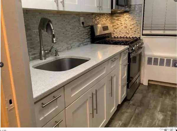 a kitchen with a sink and a stove top oven