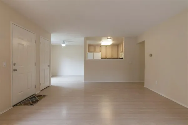 an empty room with windows and closet