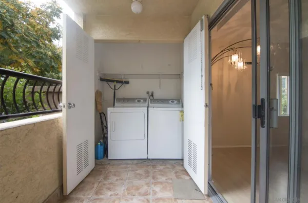 a view of a house with flower plants next to a road