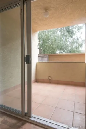 an empty room with windows and ceiling fan