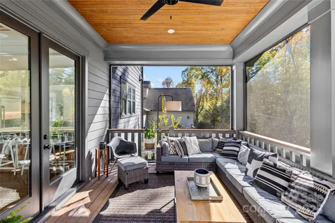 a living room with furniture and a floor to ceiling window