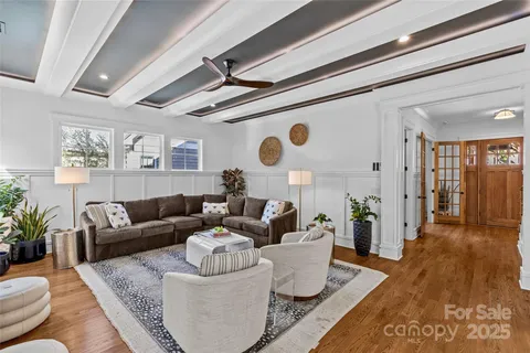 a living room with furniture and wooden floor