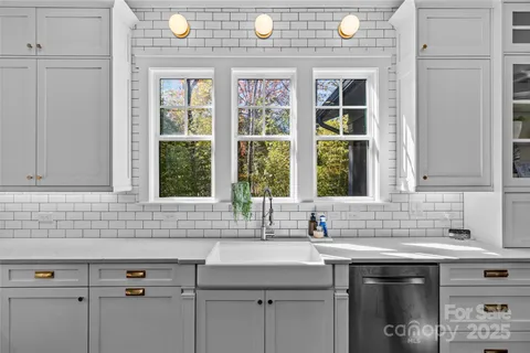a sink with a granite countertop window sink and mirror