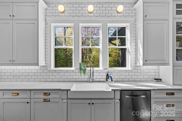 a sink with a granite countertop window sink and mirror