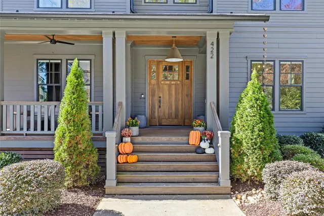 a front view of a house with potted plants