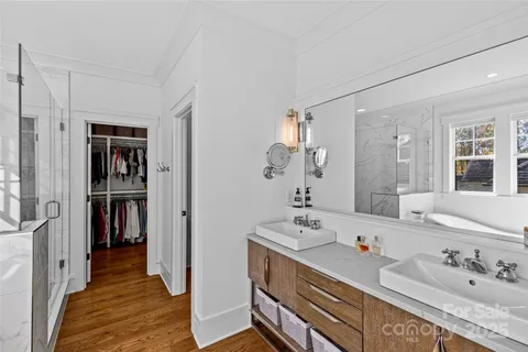 a bathroom with a tub sink and mirror