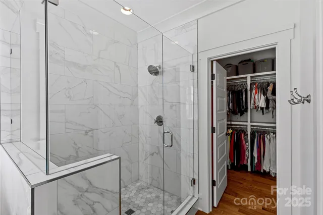 a view of a walk in closet and bathroom