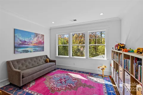 a living room with furniture and a book shelf