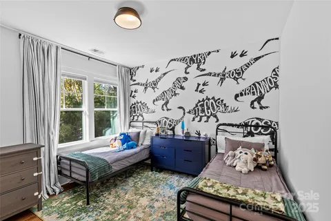 a kitchen with stainless steel appliances granite countertop a stove top oven a sink dishwasher a dining table and chairs with wooden floor