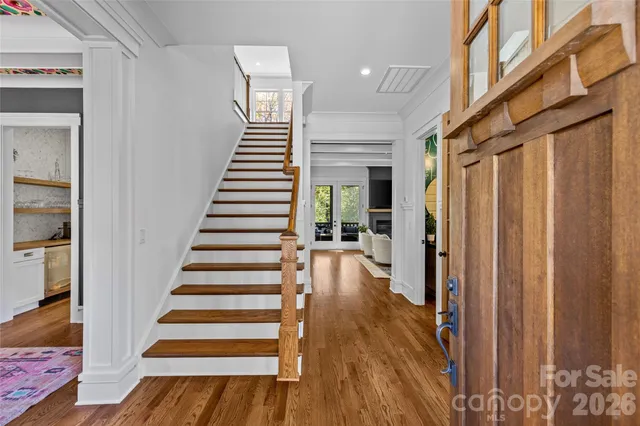 a living room with furniture a fireplace and a potted plant