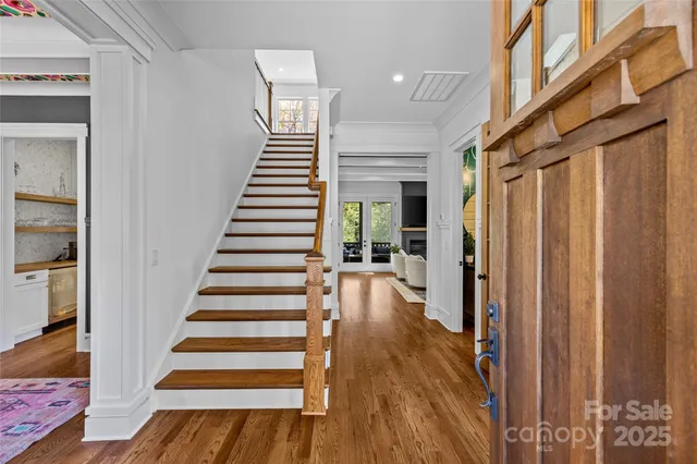 a view of entryway with wooden floor and stairs