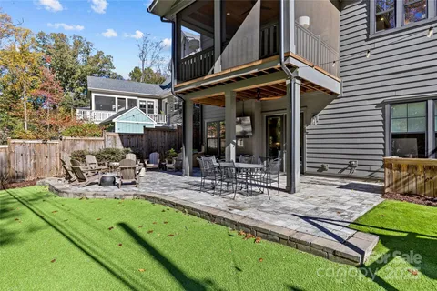 a view of an house with backyard and a table