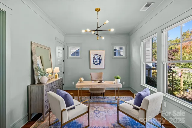 a living room with furniture a piano and a window