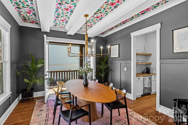 a living room with furniture fireplace and a large window
