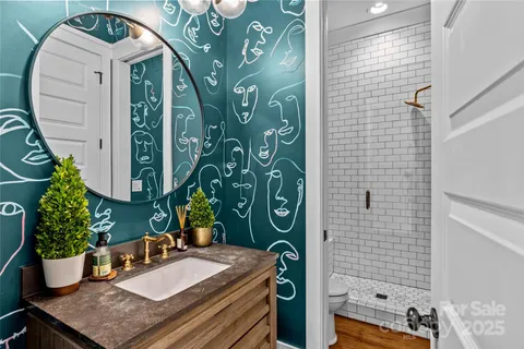 a bathroom with a potted plant and a shower