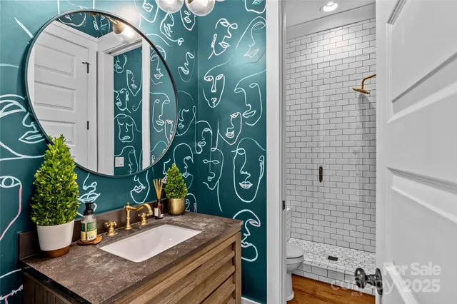 a bathroom with a potted plant and a shower