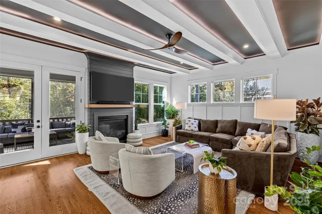 a living room with furniture a fireplace and a potted plant