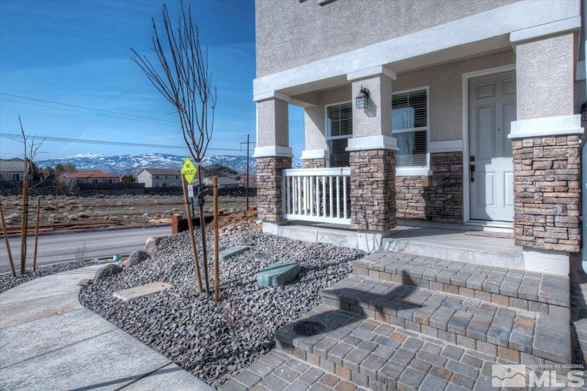 1180 Arrastra Road, Unit LOT 15 Reno, NV 89512 - Photo 2 of 34 a view of a house with backyard and porch