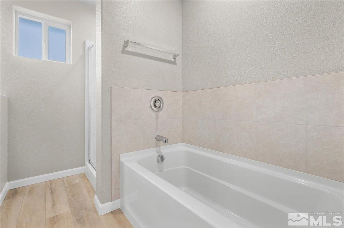 1180 Arrastra Road, Unit LOT 15 Reno, NV 89512 - Photo 26 of 34 a white bath tub sitting next to a white sink