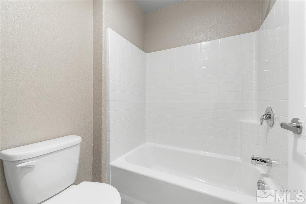 1180 Arrastra Road, Unit LOT 15 Reno, NV 89512 - Photo 32 of 34 a white toilet sitting next to a bath tub
