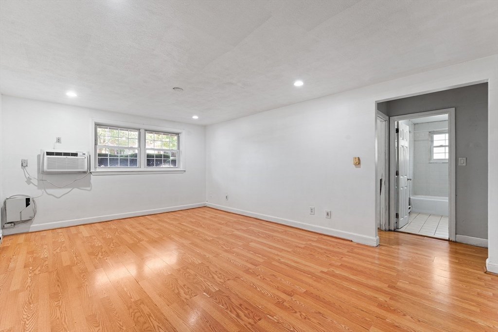 3 Walker Road, Unit 1 North Andover, MA 01845 - Photo 12 of 19 a view of empty room with wooden floor and fan