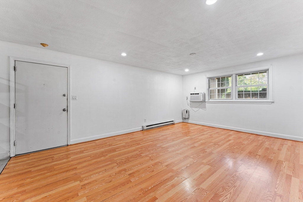 3 Walker Road, Unit 1 North Andover, MA 01845 - Photo 13 of 19 a view of an empty room with wooden floor and a window