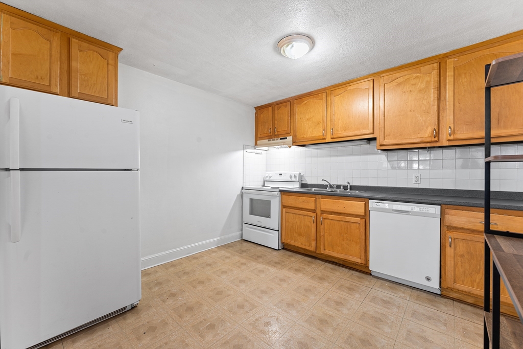 3 Walker Road, Unit 1 North Andover, MA 01845 - Photo 5 of 19 a kitchen with granite countertop cabinets and appliances
