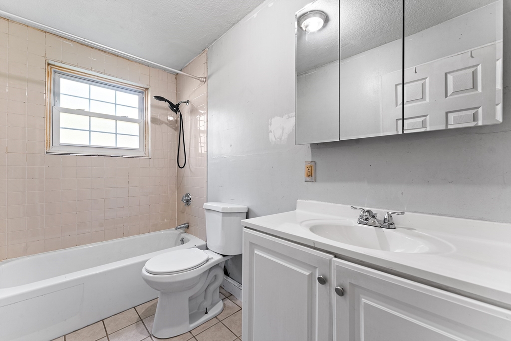 3 Walker Road, Unit 1 North Andover, MA 01845 - Photo 9 of 19 a bathroom with a sink a toilet and a bathtub