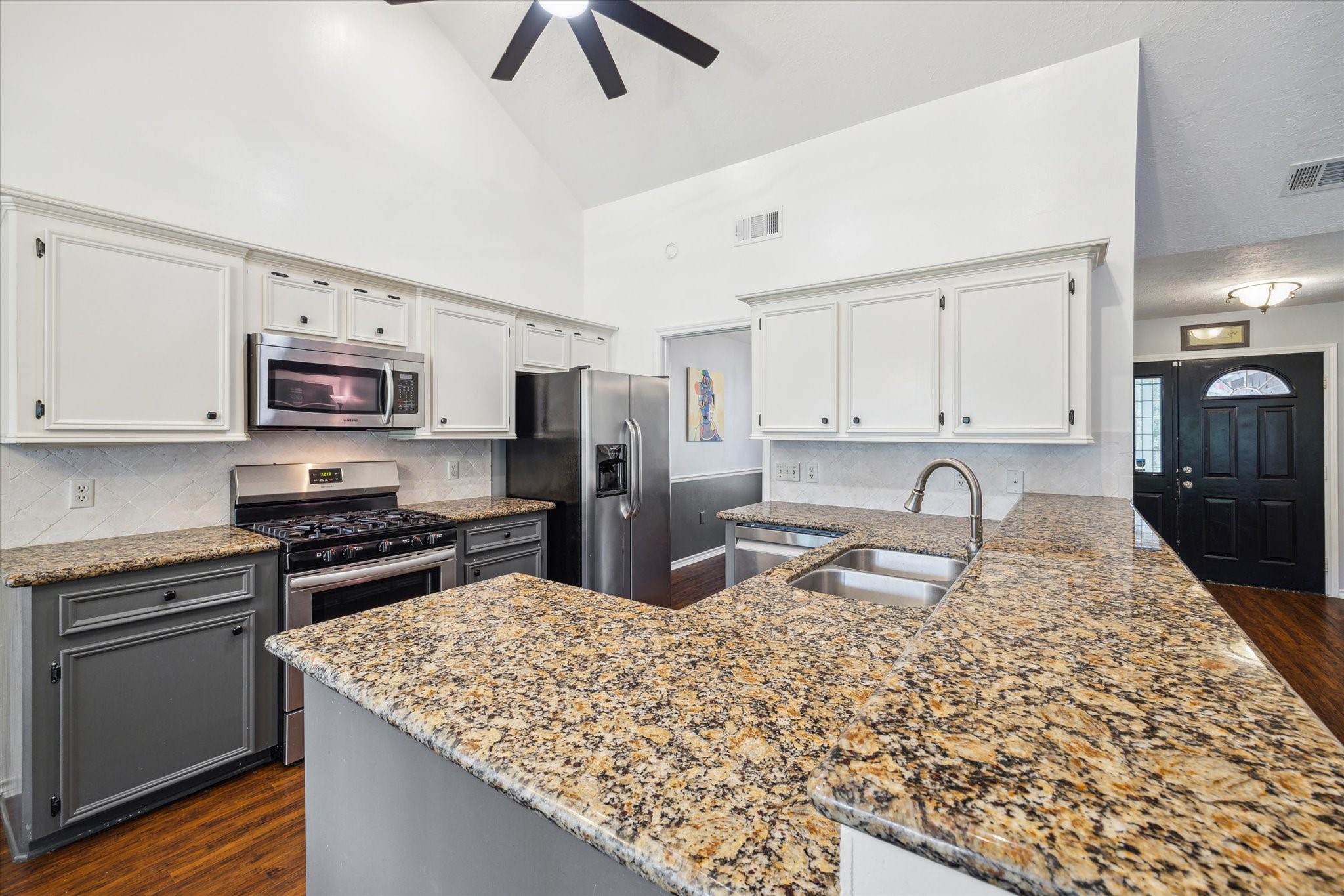 2420 Canter Lane Conroe, TX 77384 - Photo 8 of 24 a kitchen with stainless steel appliances granite countertop a sink stove microwave and refrigerator