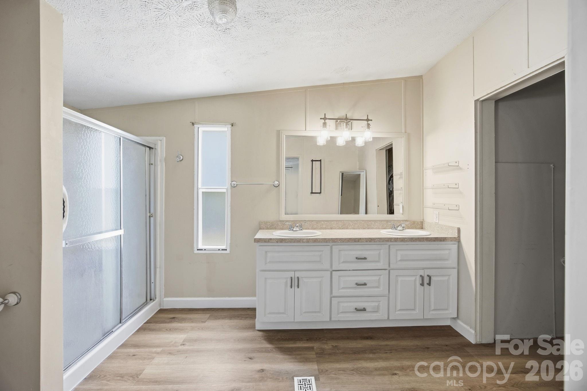 675 Overcash Road Salisbury, NC 28147 - Photo 26 of 48 a spacious bathroom with double vanity and a mirror