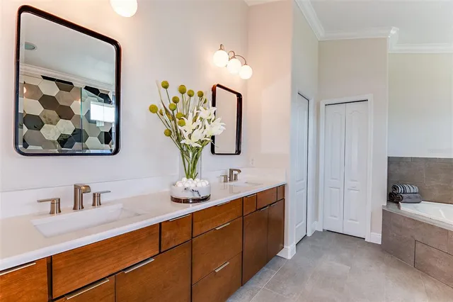 a bathroom with a double vanity sink and a mirror