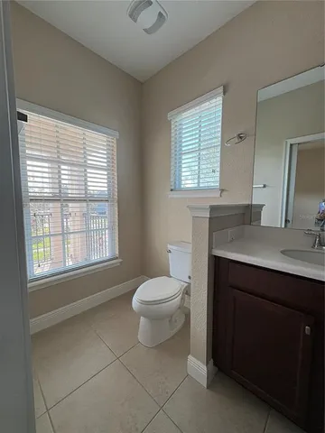 a bathroom with a sink vanity and mirror