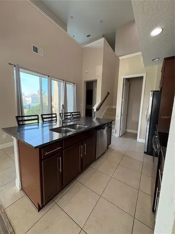 a kitchen with stainless steel appliances granite countertop a sink and a stove