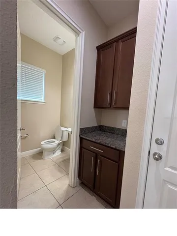 a bathroom with a sink a toilet and mirror