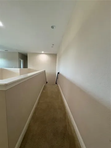 a view of a big room with kitchen and windows