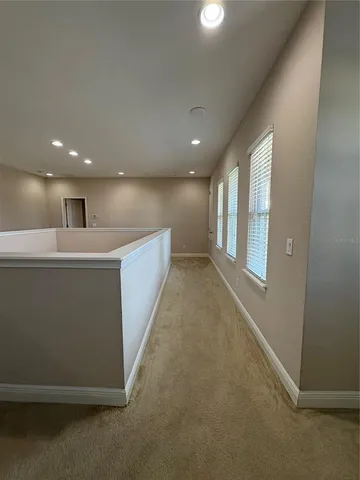 an empty room with windows and entrance