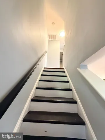 a bathroom with a sink mirror vanity and toilet