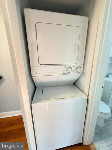 a view of a room with wooden floor and a window