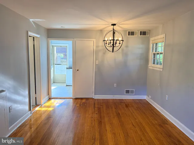 a view of a livingroom with wooden floor and a window