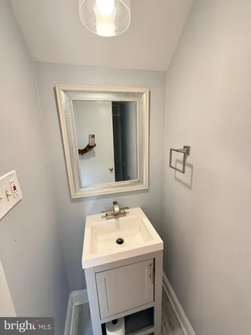 a bathroom with a sink a mirror and vanity