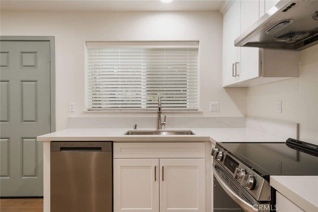 1806 South 8th Street, Unit B Alhambra, CA 91803 - Photo 20 of 44 a kitchen with granite countertop a sink and a white wooden cabinets