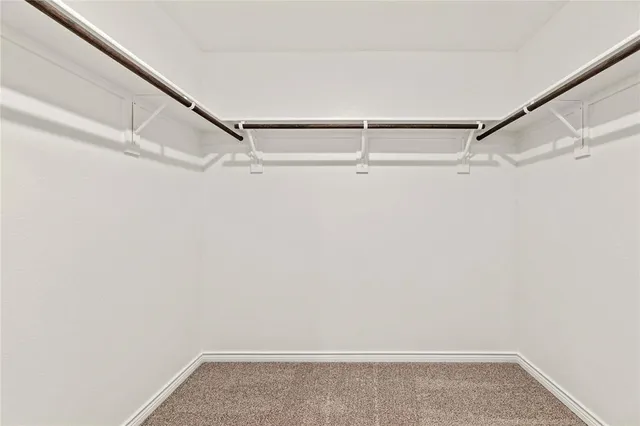 a bedroom with a bed potted plant and a flat screen tv