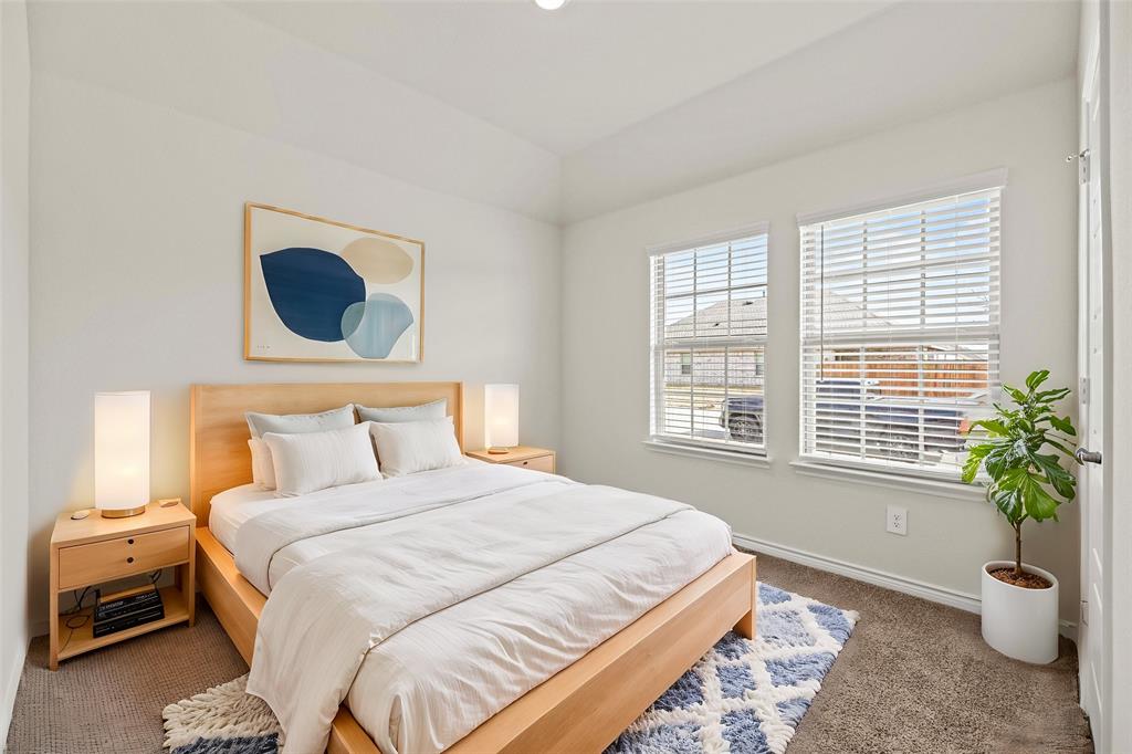 411 Revolution Road Fate, TX 75087 - Photo 15 of 34 a bedroom with a bed and a window