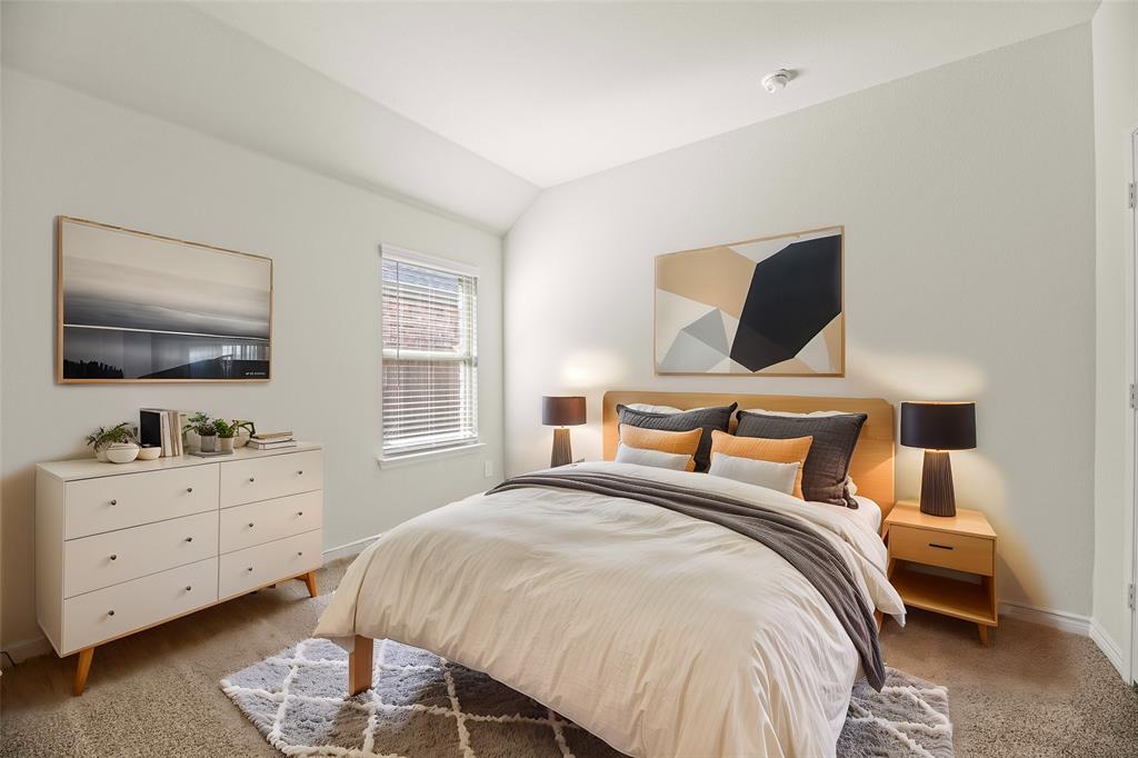 411 Revolution Road Fate, TX 75087 - Photo 17 of 34 a bedroom with a bed and a flat screen tv