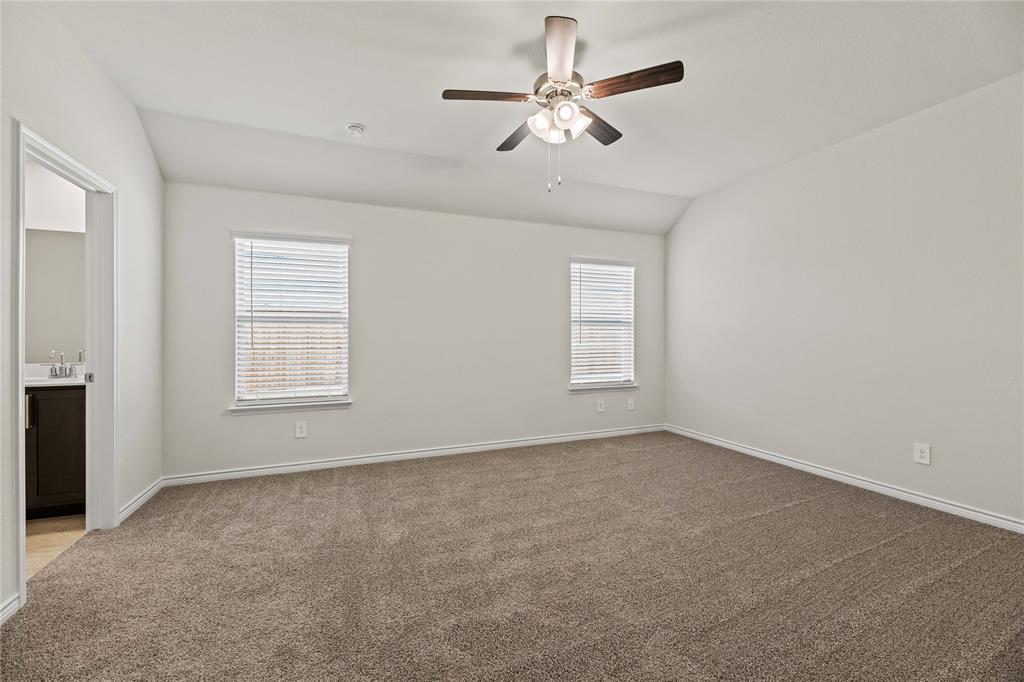 411 Revolution Road Fate, TX 75087 - Photo 23 of 34 an empty room with windows and fan